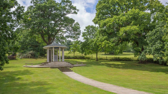 The Magna Carta memorial at Runnymede, Surrey, surrounded by trees.